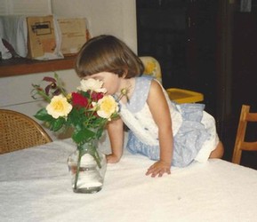 Lindy connecting with the roses and stopping to take a smell.